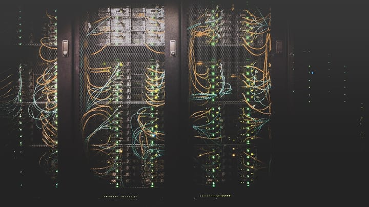 Server racks with green LEDs and cabling — illustrative of the Start Campus hyperscale build in Sines, Portugal