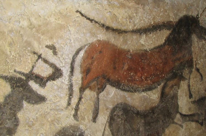 A Palaeolithic cave painting of a large animal figure on a rock wall