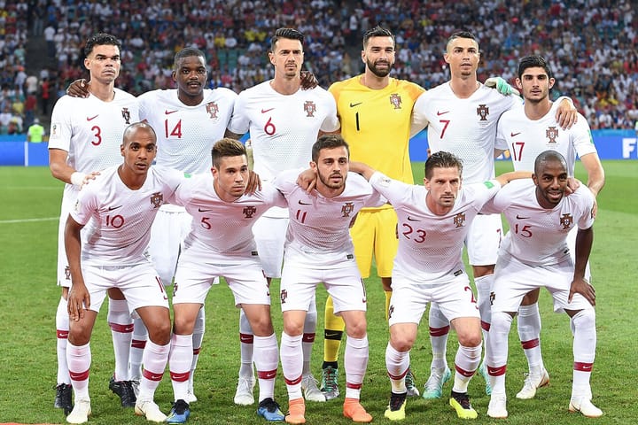 The Portugal national football team lined up for a pre-match squad photo in their white away kit, including captain Cristiano Ronaldo