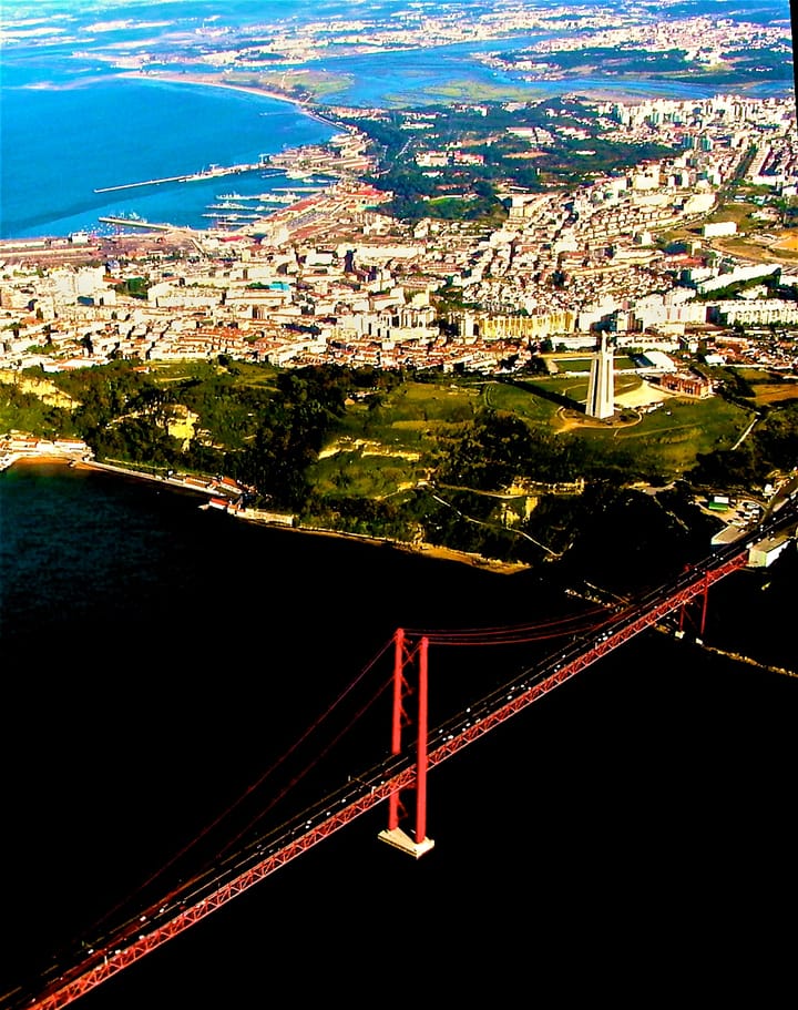 Aerial view of Almada and the Tagus estuary with the red 25 de Abril suspension bridge crossing to Lisbon