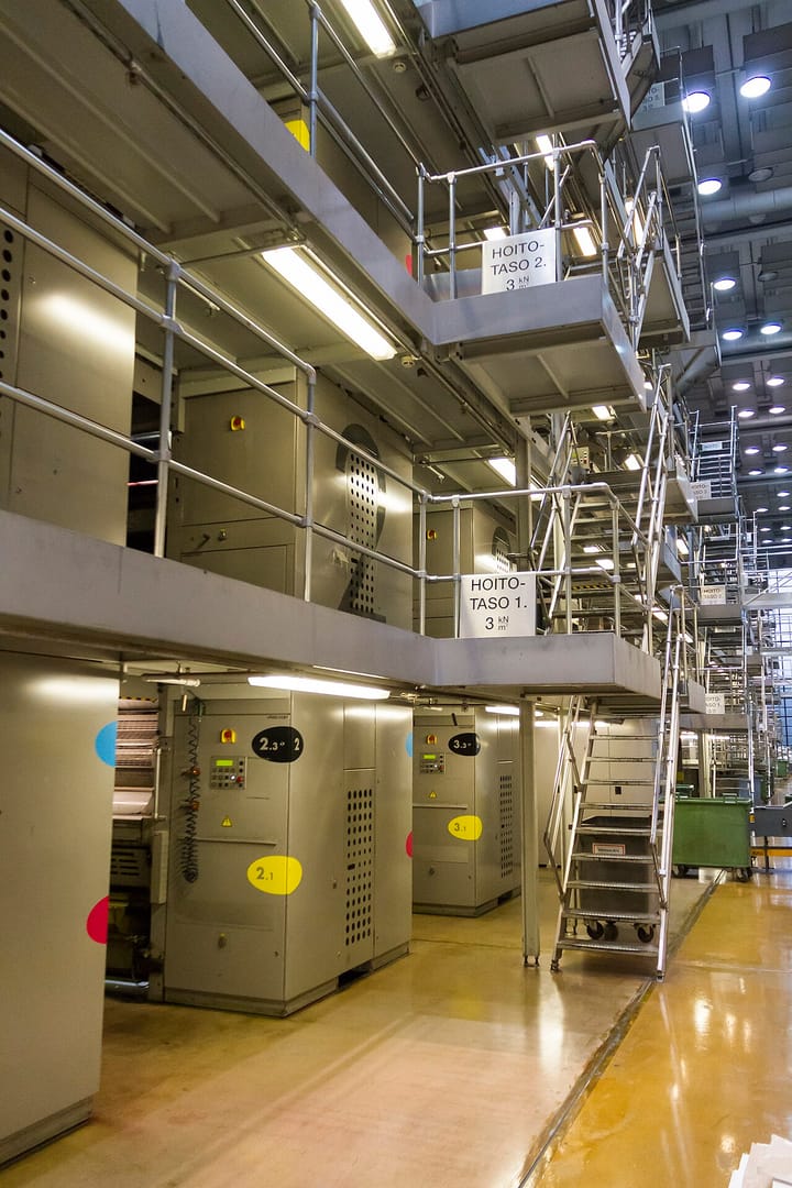The interior of a large modern industrial printing plant with multi-level press units