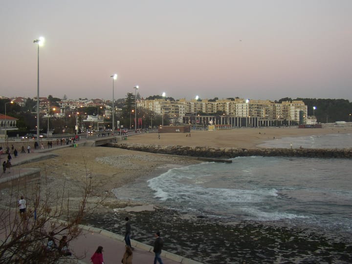 The seafront promenade and apartment blocks of Oeiras at dusk, the Lisbon-coast municipality with the highest median income in Portugal