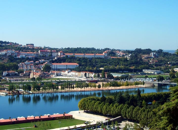 The city of Coimbra rising above the Mondego river in central Portugal on a clear day