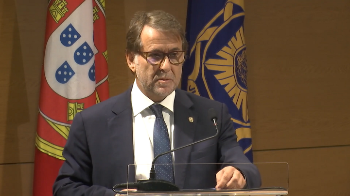 Luis Neves, Portugal's Interior Minister and former head of the Judicial Police, speaks at a podium before the Portuguese flag and the Policia Judiciaria emblem