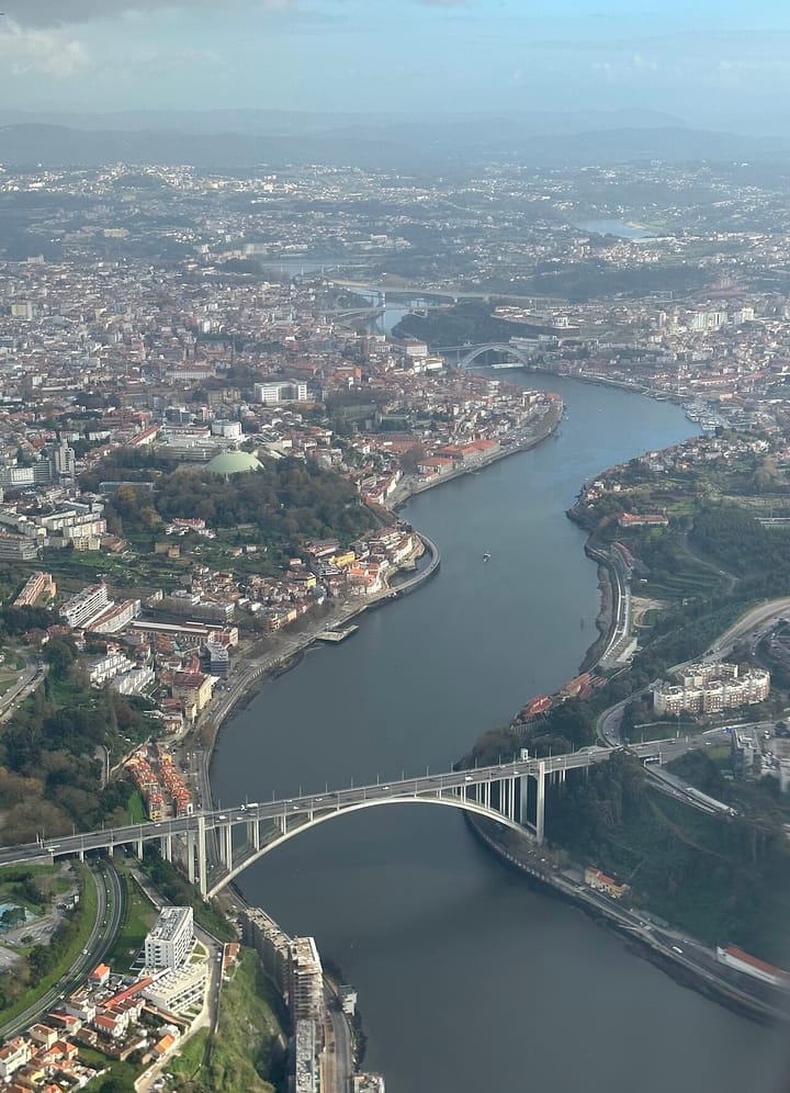 An aerial view of Porto and the Douro river with the arched Arrábida bridge in the foreground