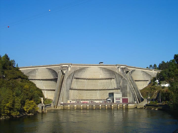 The multiple-arch Aguieira dam on the Mondego river in central Portugal under a clear blue sky