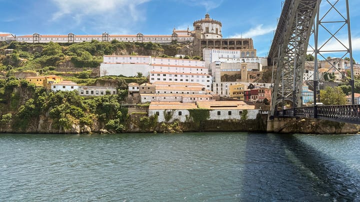 The Serra do Pilar monastery on the Gaia bank and the double-deck iron Dom Luis I Bridge spanning the river Douro at Porto under a bright summer sky