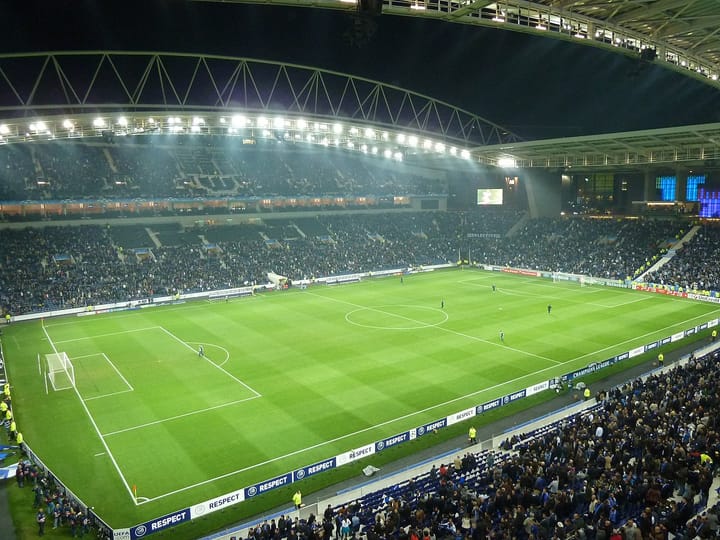 The Estadio do Dragao in Porto packed with spectators under floodlights during an evening football match