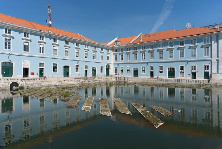 The historic Arsenal da Marinha building and Doca da Caldeirinha at Cais do Sodré in central Lisbon