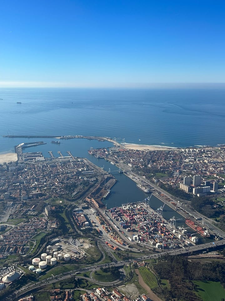 Daytime aerial view of Matosinhos showing the city, the Leixoes port basins with container terminal, the marina and the surrounding residential blocks