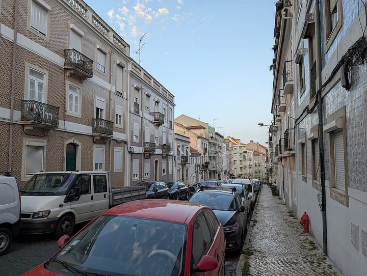 A residential street of azulejo-tiled apartment buildings in Lisbon, Portugal