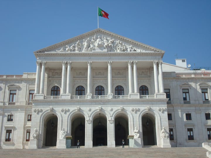 The neoclassical facade of the Palacio de Sao Bento, seat of Portugal's Assembleia da Republica, with the national flag flying, in Lisbon
