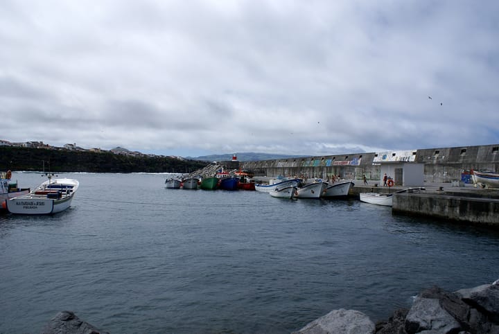 Fishing boats moored inside the harbour wall at Rabo de Peixe, Ribeira Grande, on the north coast of Sao Miguel in the Azores