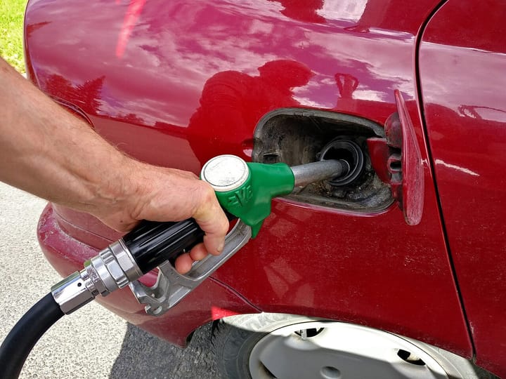 A motorist refuelling a car at a petrol pump