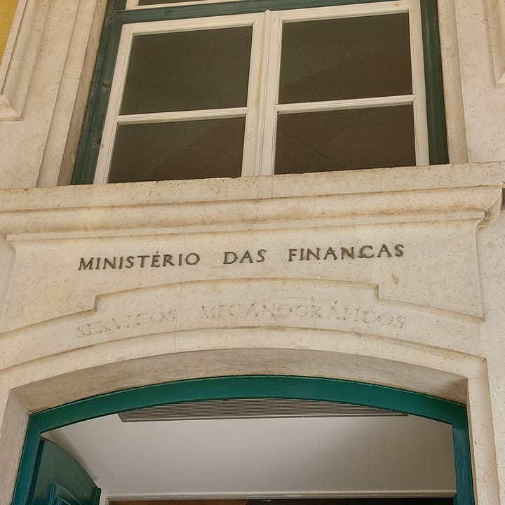 The stone facade of the Ministerio das Financas at Praca do Comercio in Lisbon, with the words MINISTERIO DAS FINANCAS engraved in the marble surround