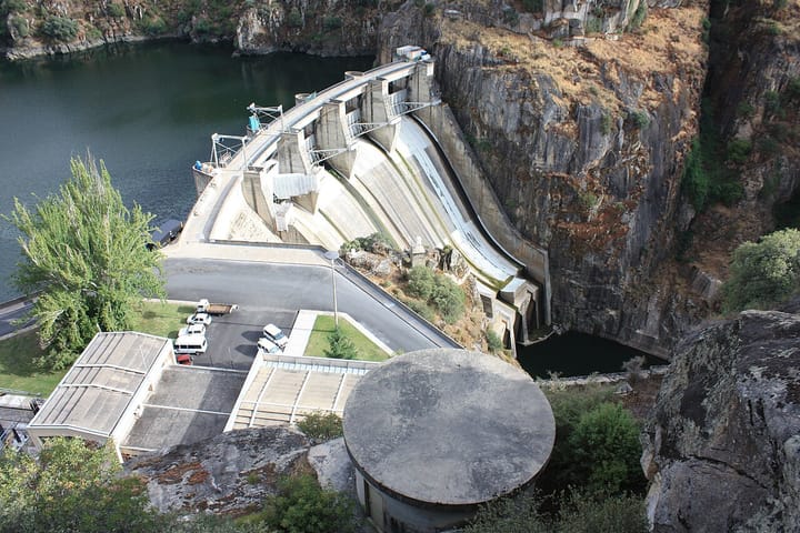 The concrete arch of the Barragem de Picote hydroelectric dam in a rocky Douro gorge, one of the six dams EDP sold to an Engie-led consortium in 2020