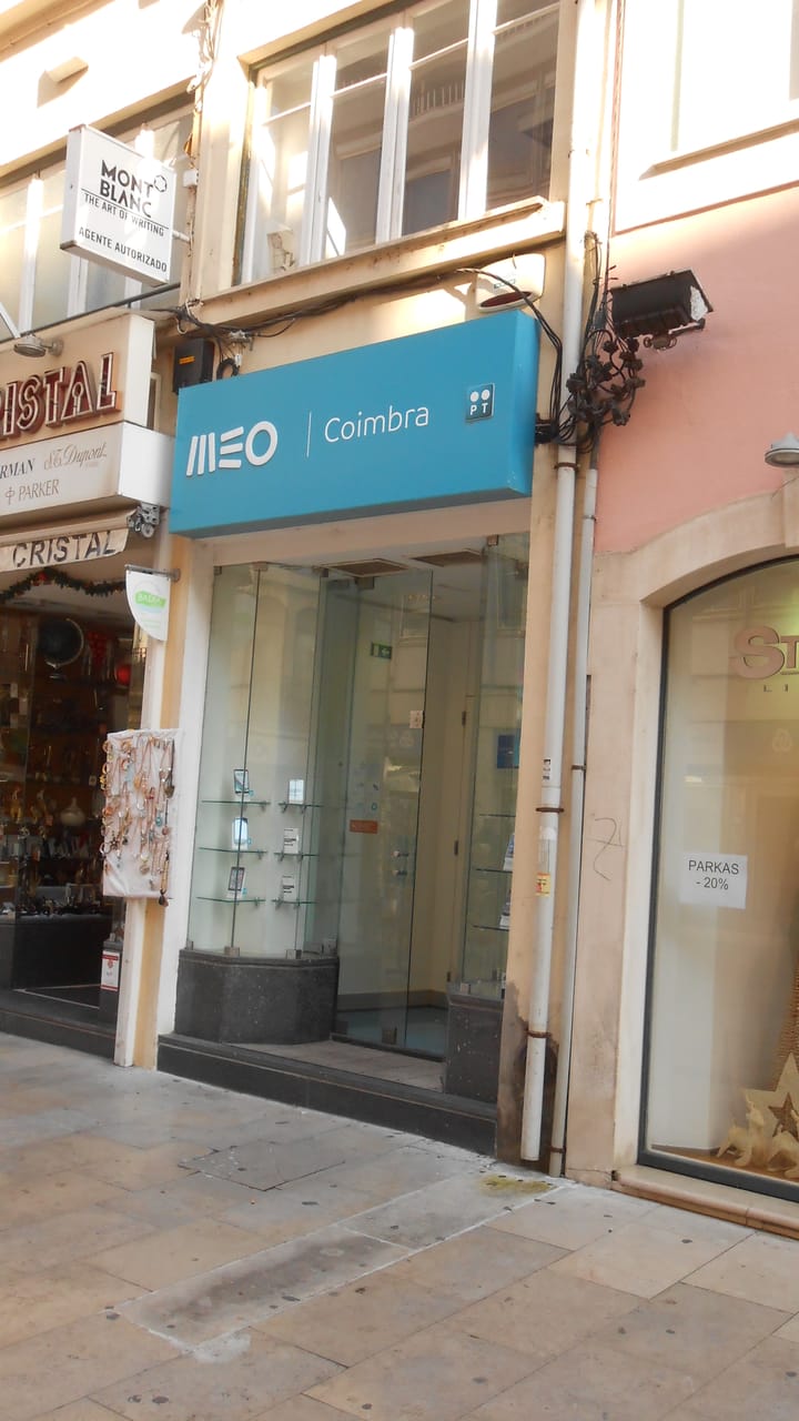 A MEO telecom store with its teal sign on a pedestrian street in Coimbra, Portugal