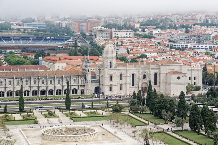 The Jeronimos Monastery in Belem, Lisbon, seen from above with its formal gardens and a queue of visitors at the entrance