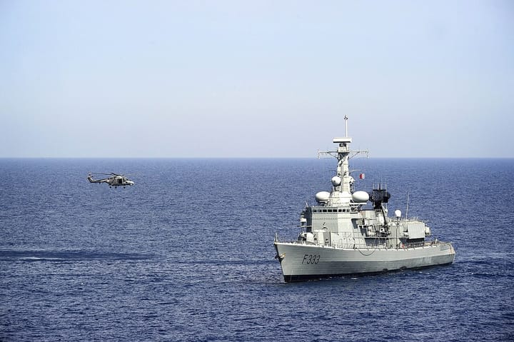 A Portuguese Navy frigate, pennant number F333, at sea as a Lynx helicopter approaches to land — the kind of ship Portugal plans to buy through the EU's SAFE defence programme