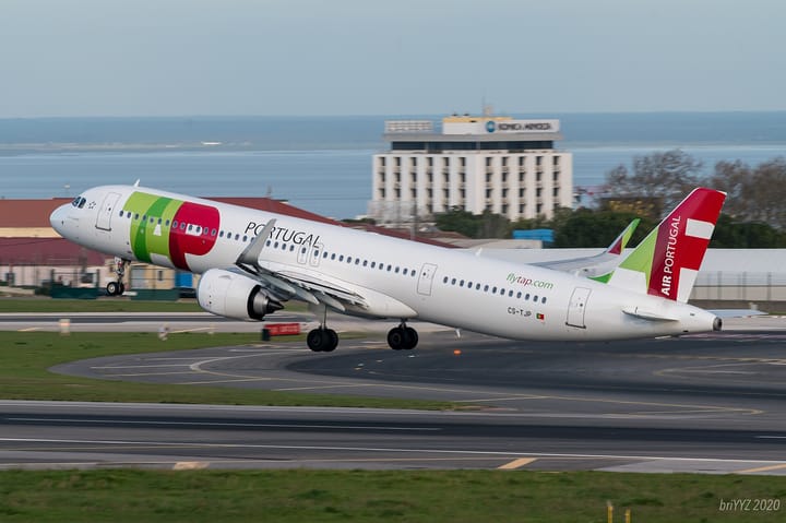 A TAP Air Portugal Airbus A321neo lifting off from Lisbon Airport with the Tejo estuary in the background