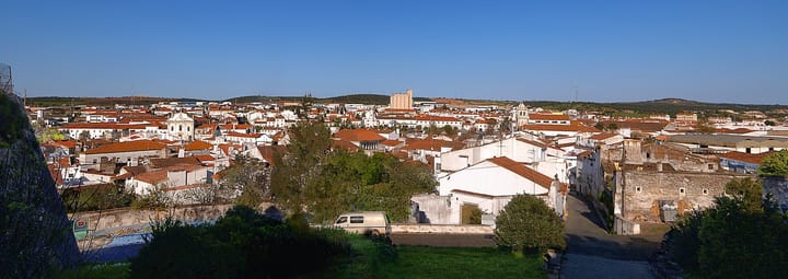 Panoramic view over the whitewashed houses and red-tiled roofs of Estremoz in the Alentejo under a clear blue sky
