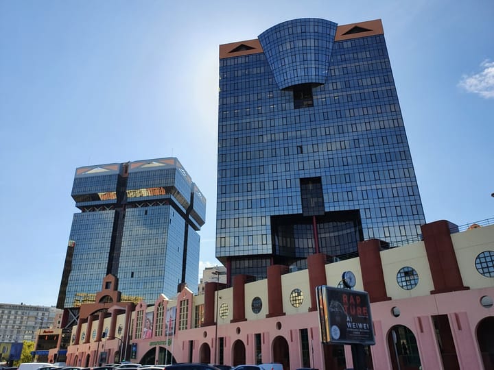 The glass Amoreiras office towers above the pink postmodern shopping centre in Lisbon