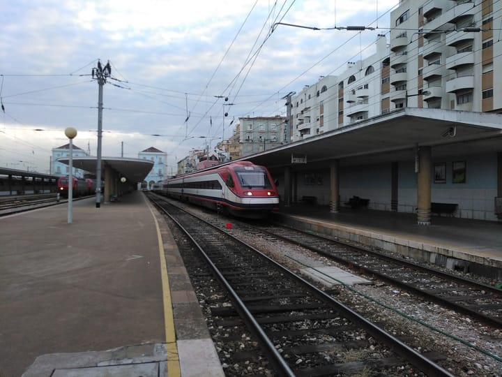 An Alfa Pendular train waiting at a platform in Lisbon's Santa Apolonia station
