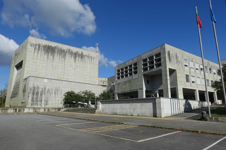 The Faculty of Engineering of the University of Porto, concrete buildings with flags outside under a blue sky