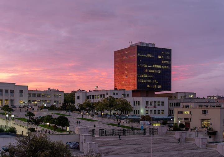 The Instituto Superior Técnico campus on the Alameda in Lisbon at sunset, with its dark glass tower