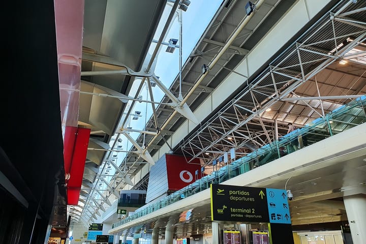 Departures signage in Portuguese and English inside Terminal 1 of Lisbon's Humberto Delgado Airport