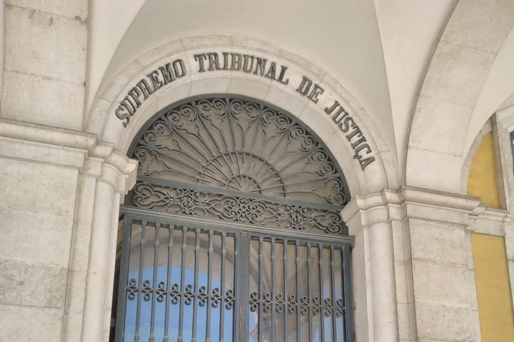 The carved stone lettering Supremo Tribunal de Justiça above the wrought-iron entrance gate of Portugal's Supreme Court in Lisbon