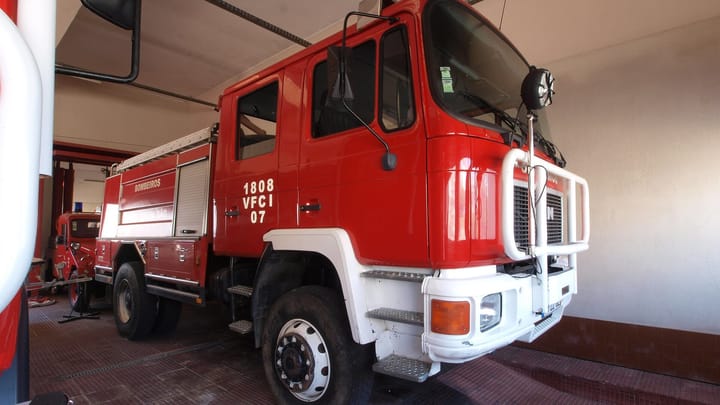 A red and white volunteer firefighters' forest fire engine marked Bombeiros parked inside a fire station in Santa Comba Dão, in the district of Viseu