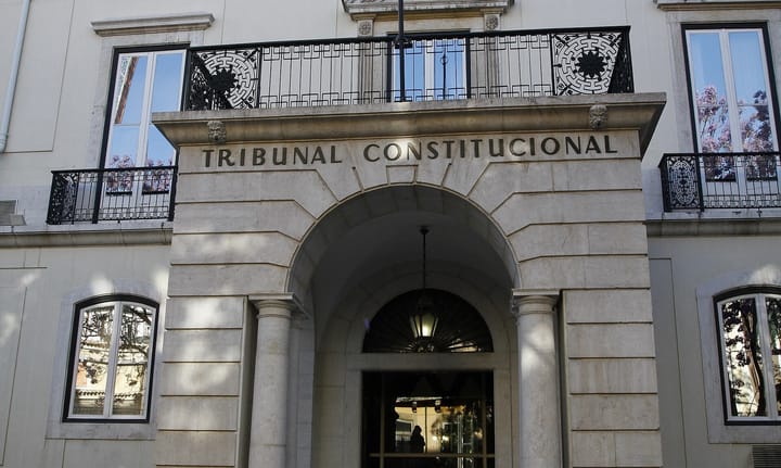 The arched stone entrance of Portugal's Constitutional Court in Lisbon, with the words Tribunal Constitucional carved into the lintel above the doorway