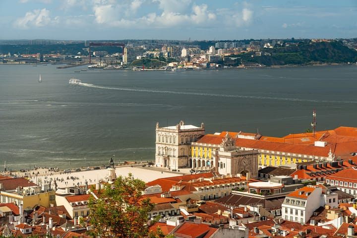 Lisbon seen from the Castelo de Sao Jorge, with the Praca do Comercio and its yellow wings on the waterfront and the Tagus and the far bank beyond