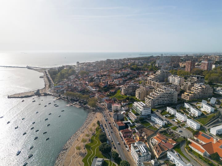 Aerial view of Lordelo do Ouro in Porto, with apartment blocks, the riverside road and boats moored at the mouth of the Douro