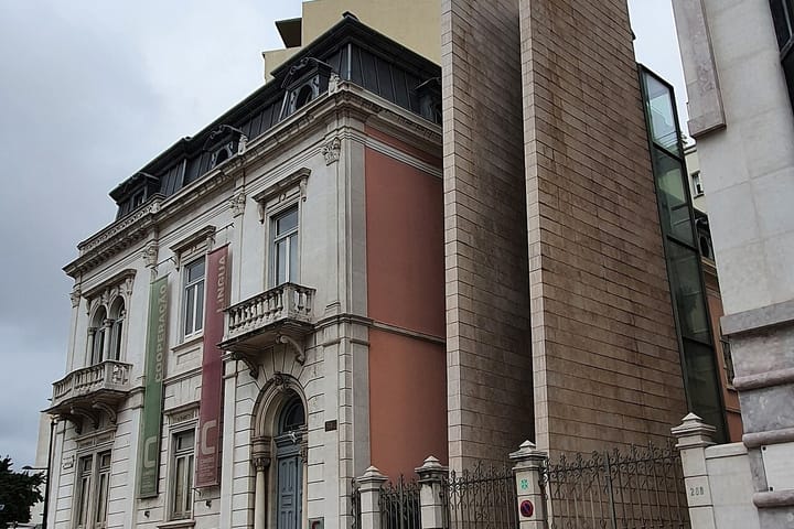 The headquarters of the Camões Institute in Lisbon, a nineteenth-century mansion hung with banners reading Cooperação and Língua
