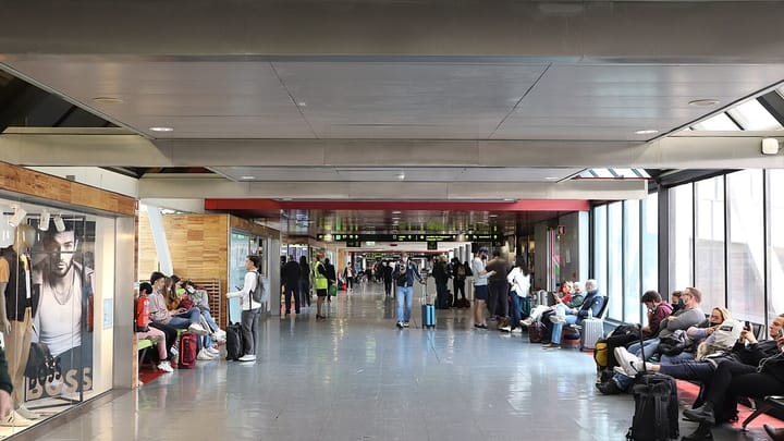 Passengers waiting in the departures concourse of Terminal 1 at Lisbon's Humberto Delgado Airport